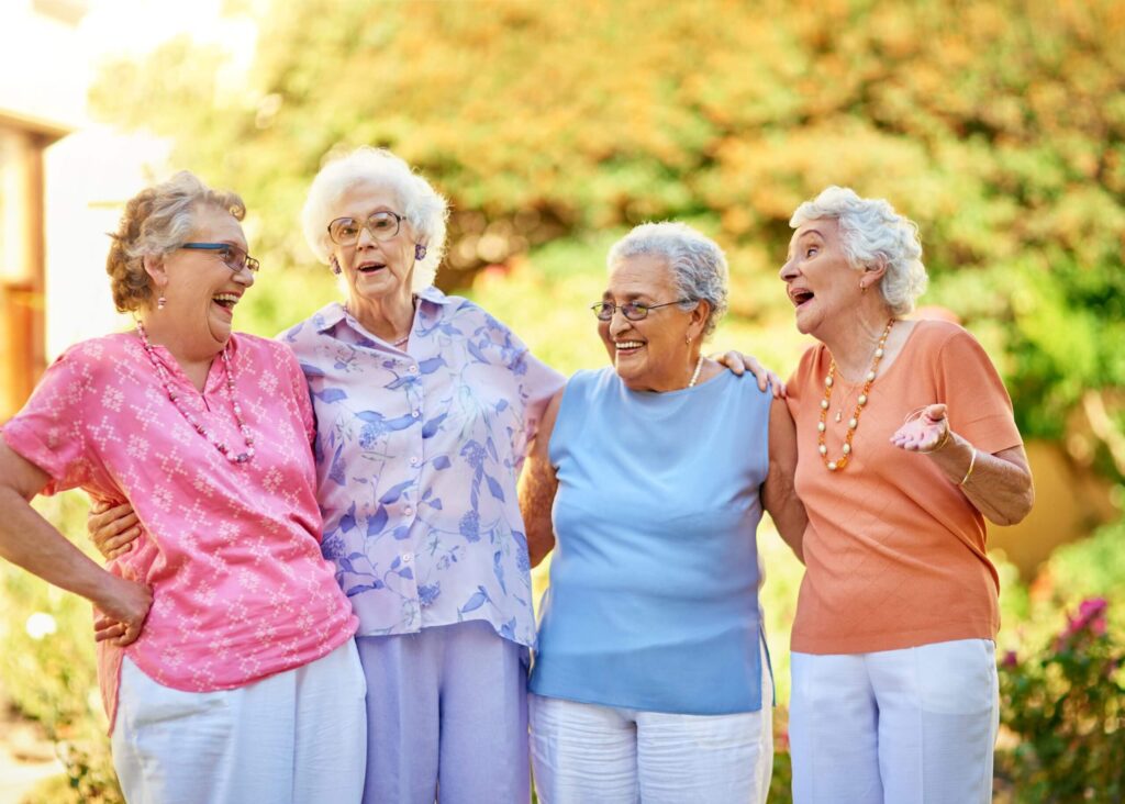 Cropped shot of a group of seniors laughing while standing outside